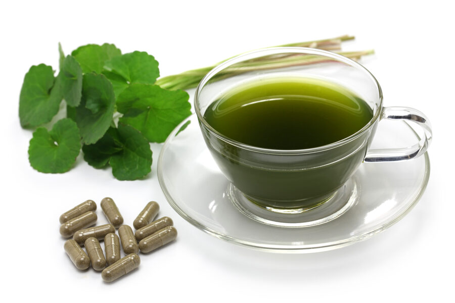Gotu kola leaves with capsules and a cup of gotu kola infusion